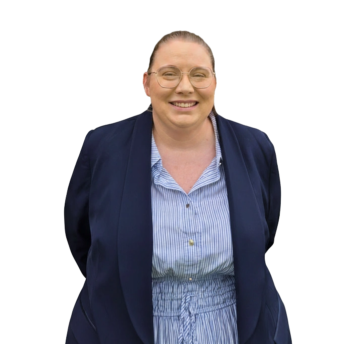 Portrait of a smiling woman in a navy blazer and light blue striped blouse, facing the camera.